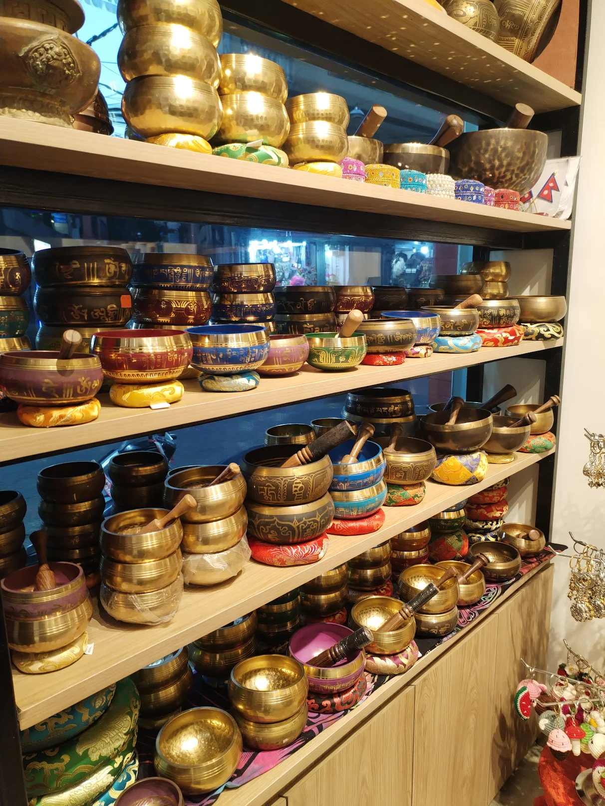 Singing bowls of every size on silk cushions
